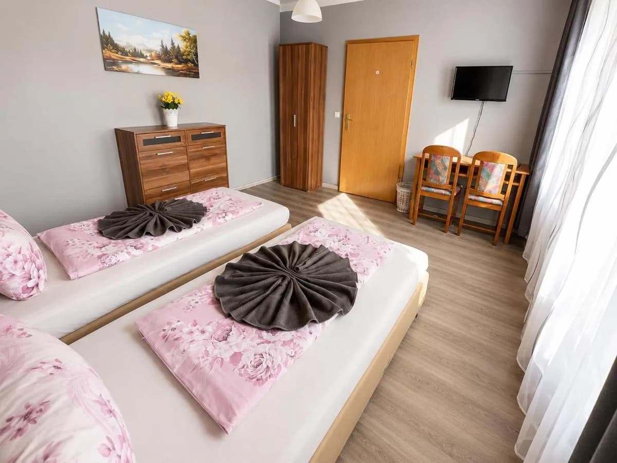 Zimmer mit zwei Einzelbetten und Kommode in Blomberg